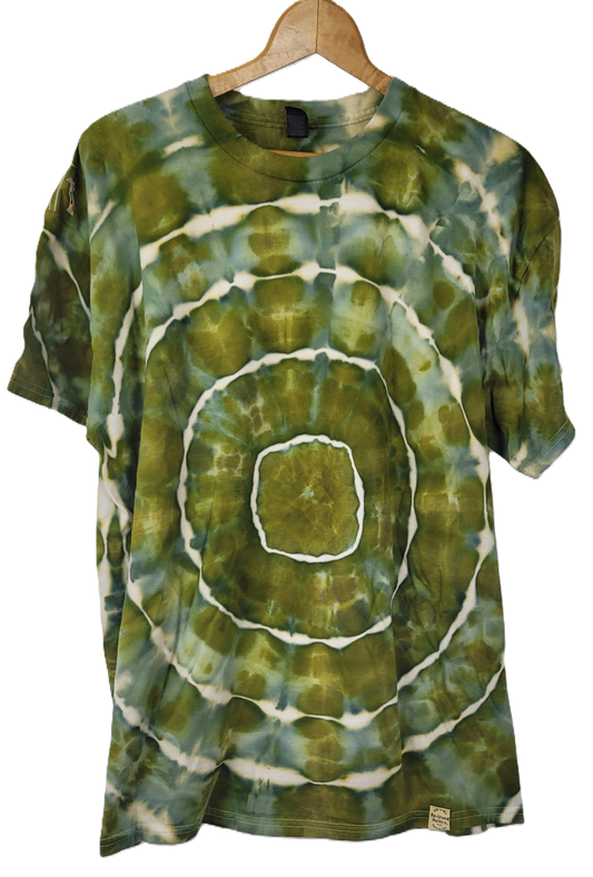 Green and white tie-dye t-shirt on a wooden hanger