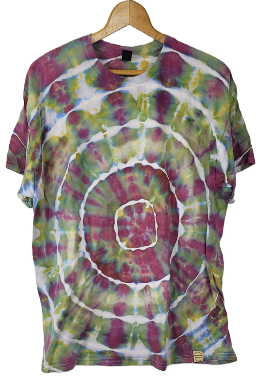 Tie-dye t-shirt with a spiral pattern on a hanger against a white background