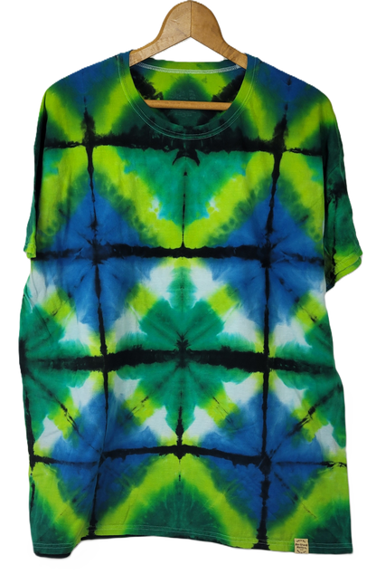 Tie-dye t-shirt with green, blue, and black pattern on a hanger