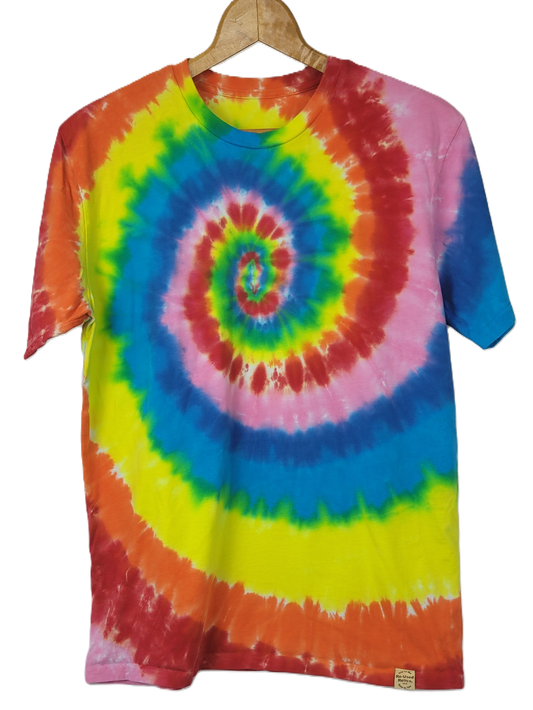 Tie-dye t-shirt with a spiral pattern on a hanger against a white background