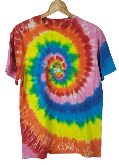 Colorful tie-dye t-shirt on a hanger with a white background