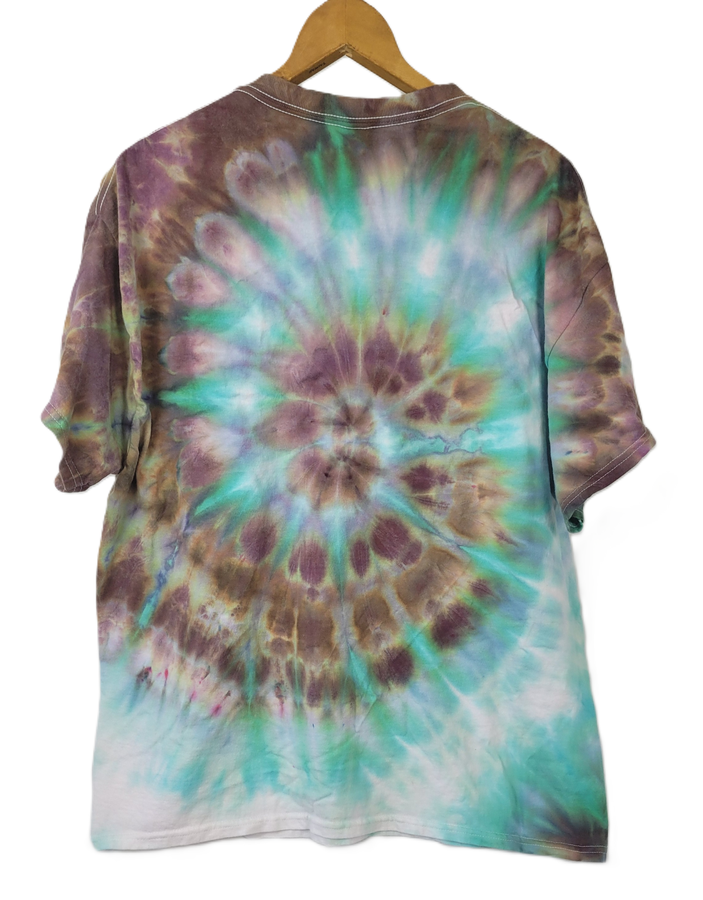 Tie-dye shirt with a spiral pattern on a hanger