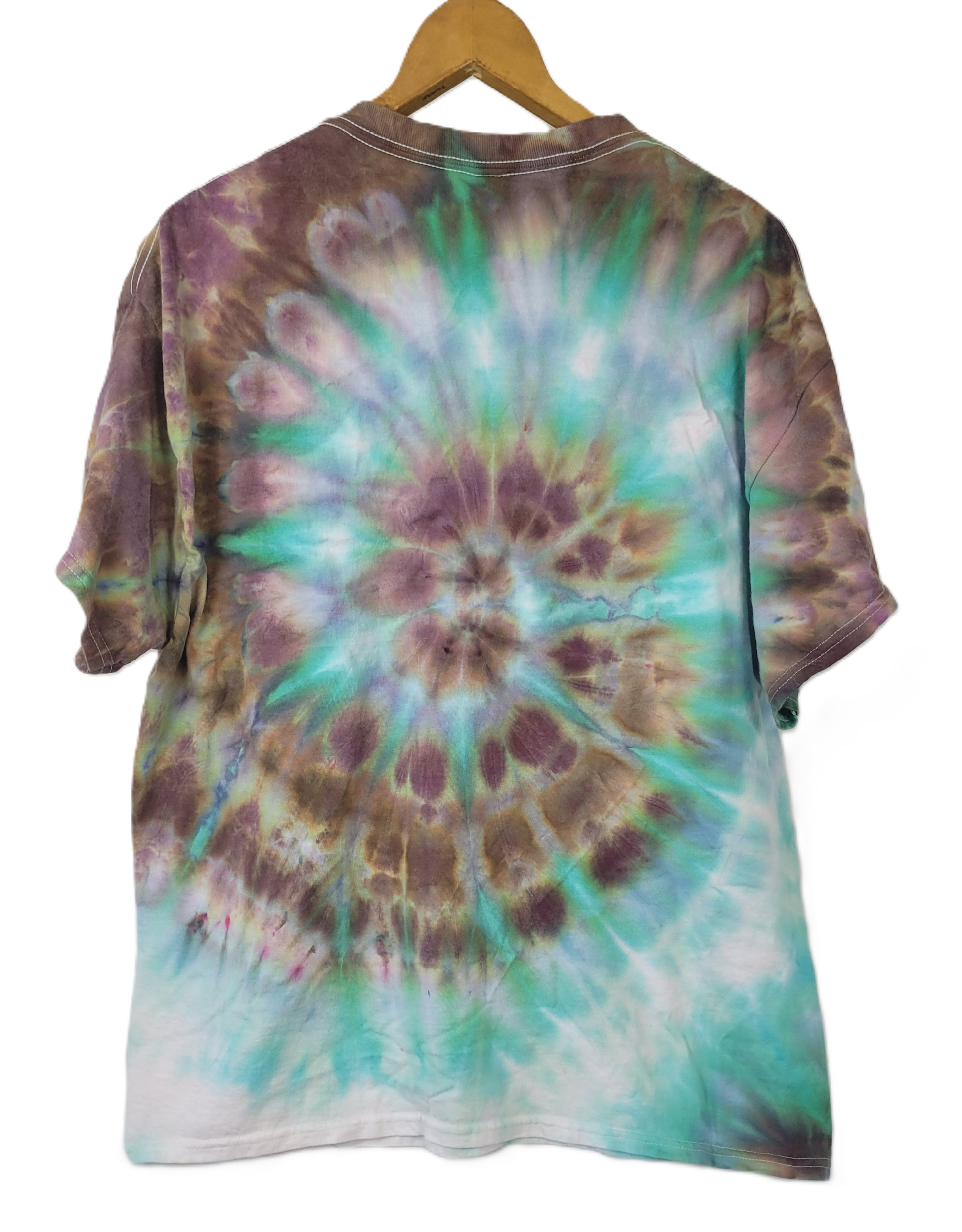 Tie-dye shirt with a spiral pattern on a hanger