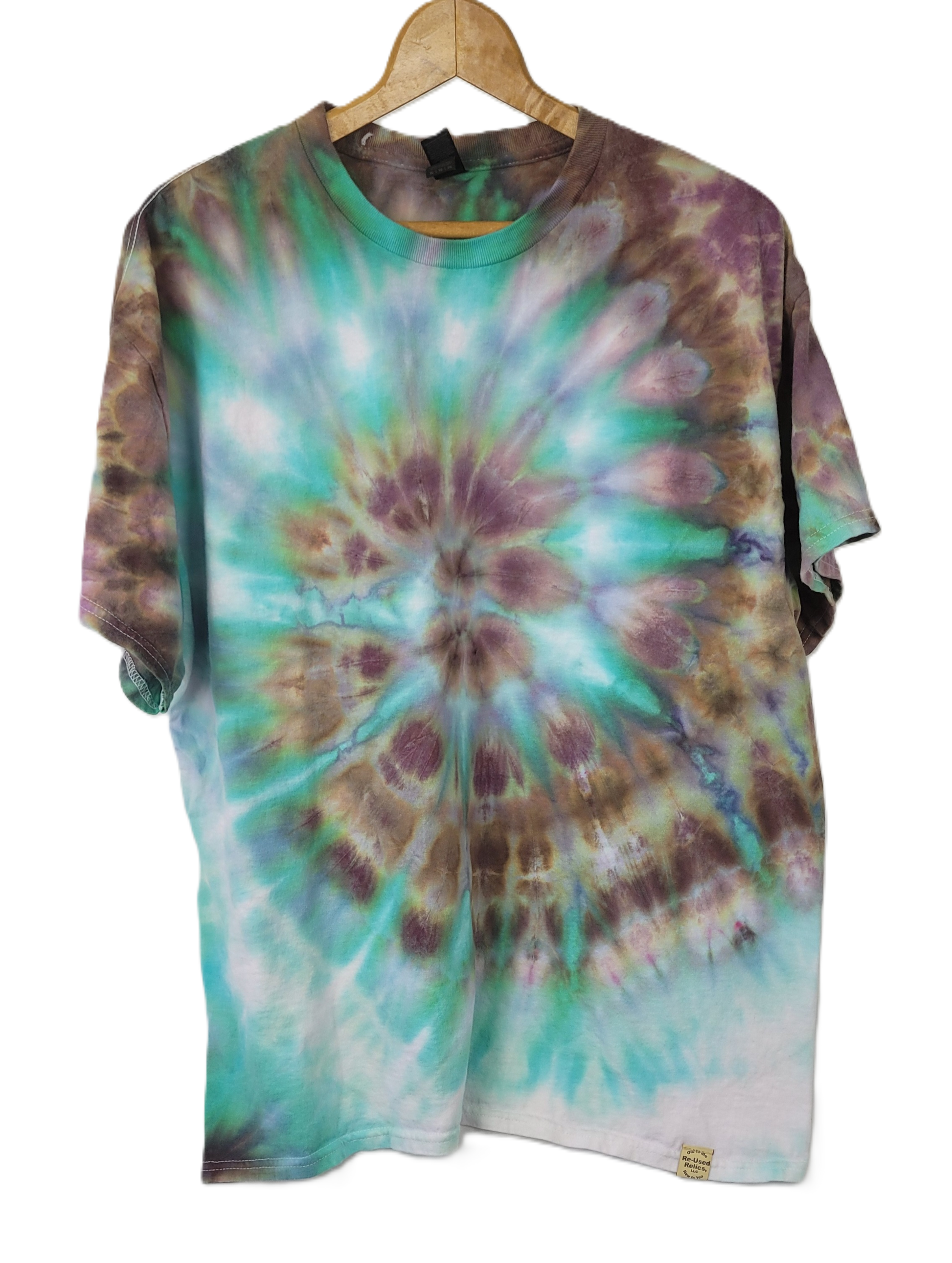 Tie-dye shirt with a spiral pattern on a hanger against a white background