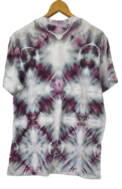Tie-dye t-shirt on a wooden hanger with a white background