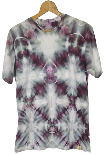 Tie-dye t-shirt on a wooden hanger with a white background