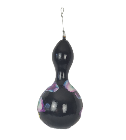 Decorative black gourd with colorful patterns on a white background