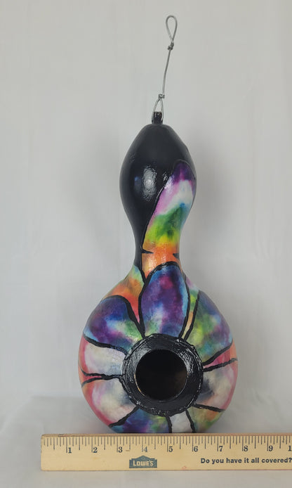 Colorful birdhouse with a black top on a white background