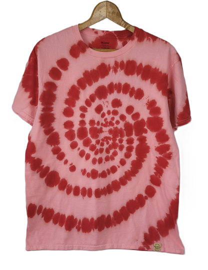 Pink and red tie-dye t-shirt on a hanger with a white background