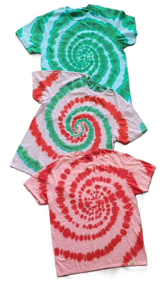 Three tie-dye t-shirts with spiral patterns in green, red, and pink on a white background.