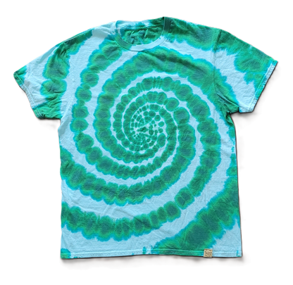 Tie-dye t-shirt with green and blue spiral pattern on a white background