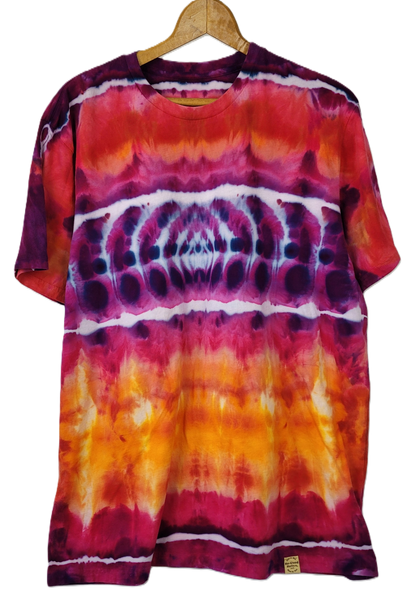 Tie-dye t-shirt with a spiral pattern on a hanger against a white background