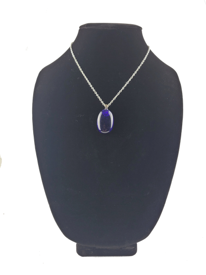 Necklace with a blue pendant on a black mannequin bust