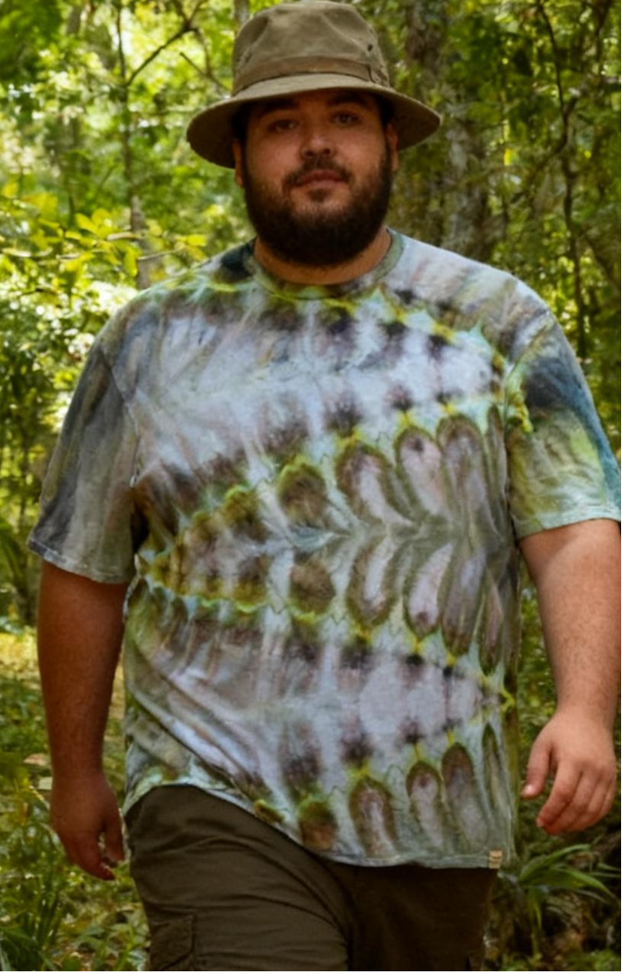 male model wearing a tie-dye shirt in a forest