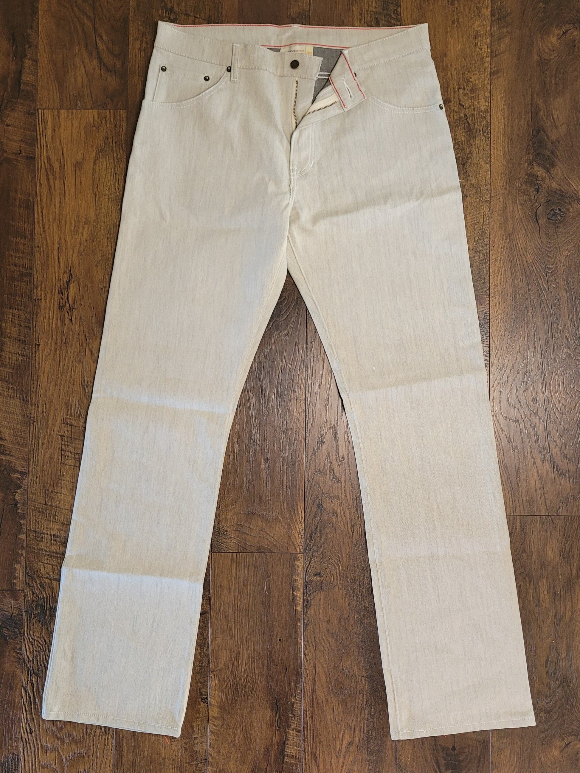 Beige jeans on a wooden floor