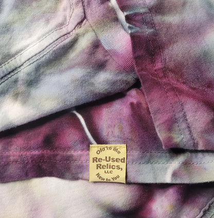 Close-up of a tie-dye shirt with a 'Old to New Re-Used Relics, LLC' label.