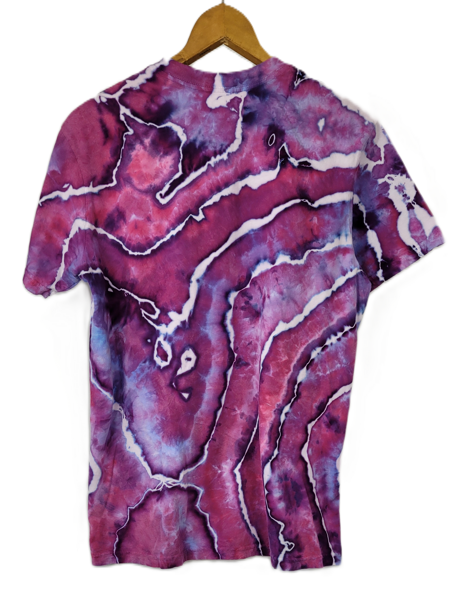 Marbled purple and pink t-shirt on a hanger with a white background