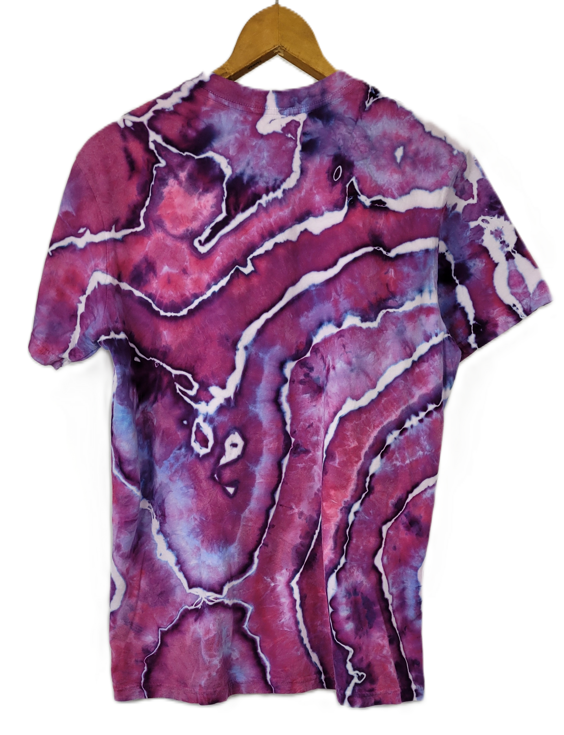 Marbled purple and pink t-shirt on a hanger with a white background