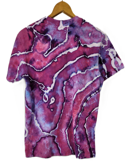 Marbled purple and pink t-shirt on a hanger with a white background