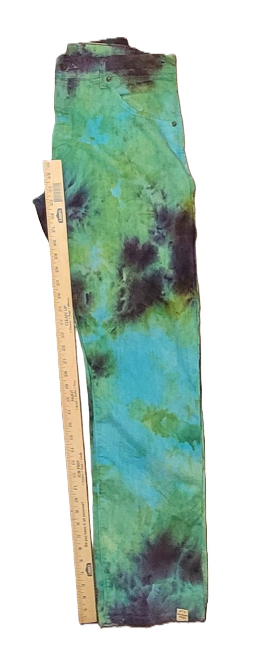 Tie-dye pants with a ruler for size reference on a white background
