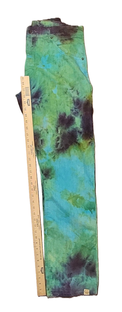 Tie-dye pants with a ruler for size reference on a white background