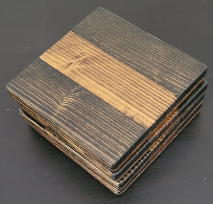 Stack of square wooden coasters with a striped pattern on a dark surface