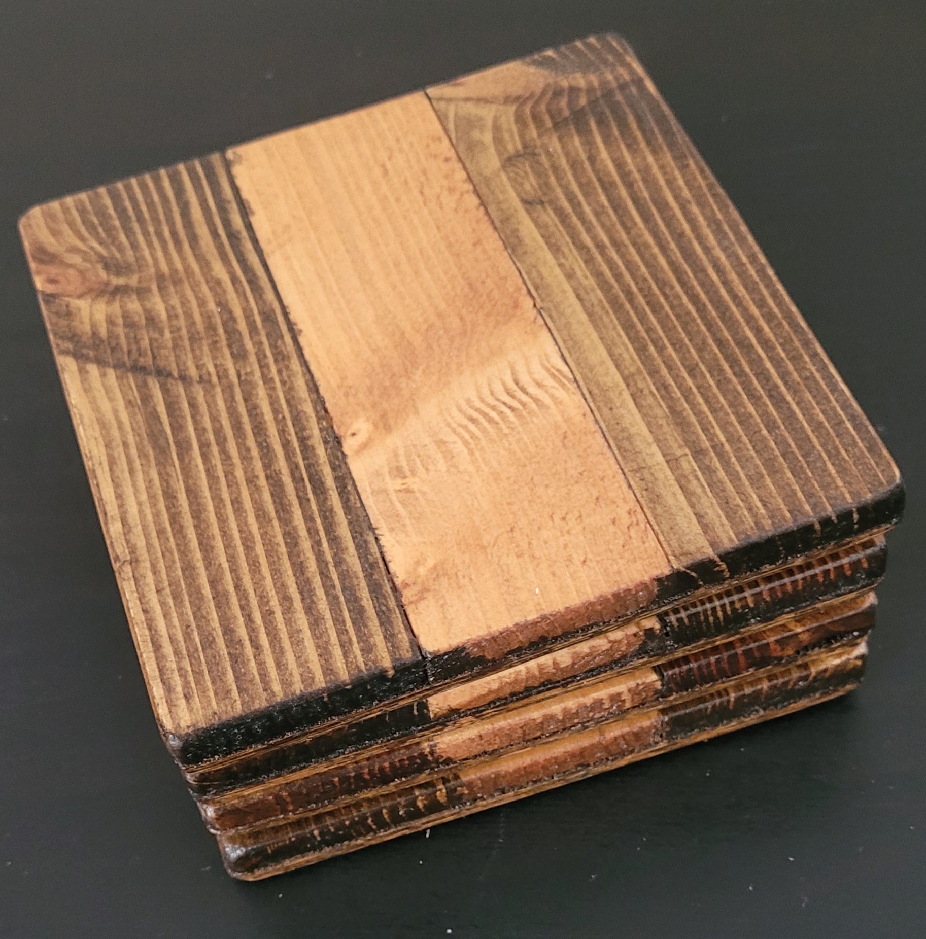 Stack of wooden coasters with a dark background