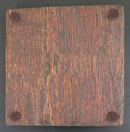 Bottom of wooden coaster with four felt pads.