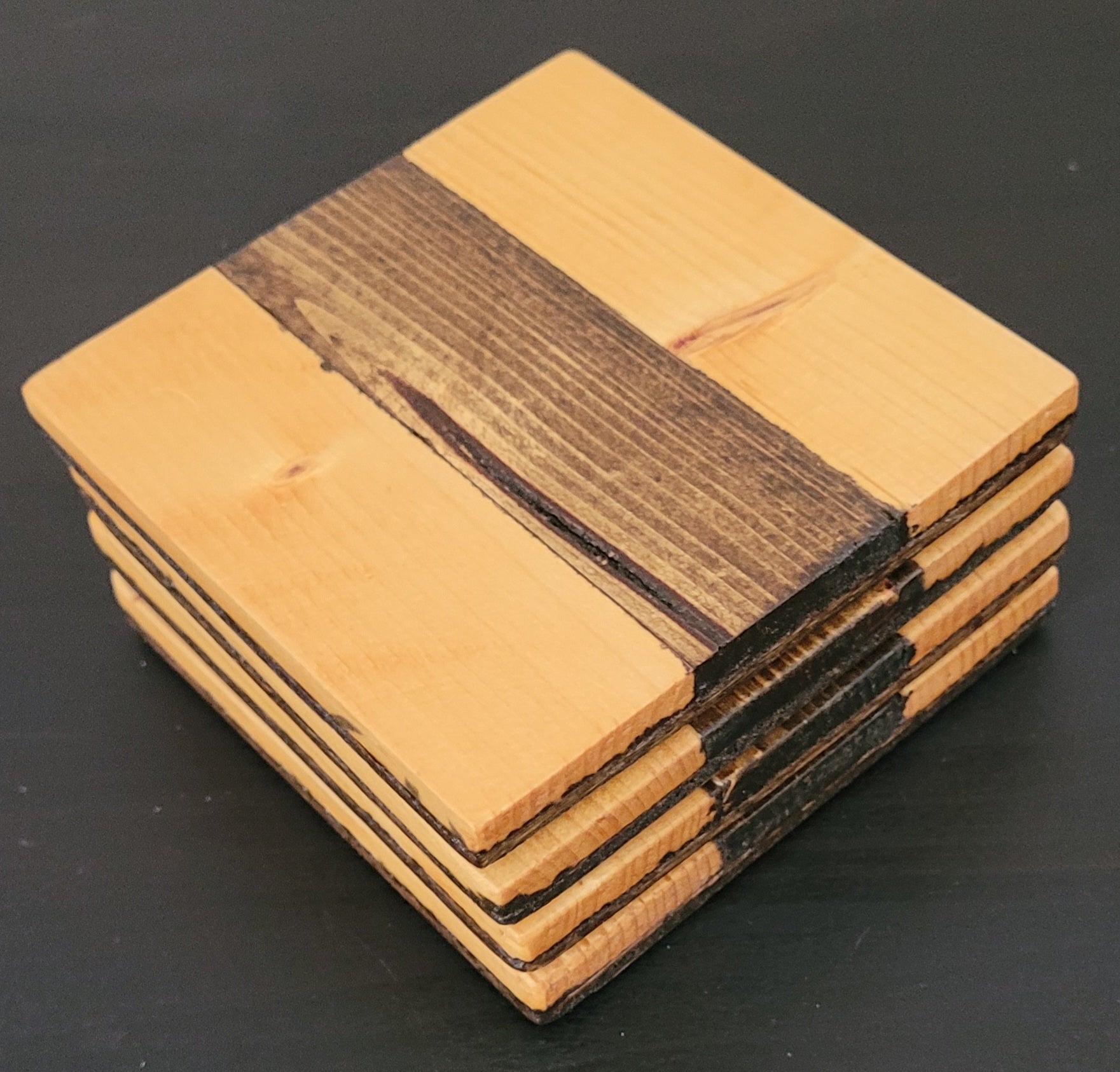 Stack of wooden coasters with a dark background