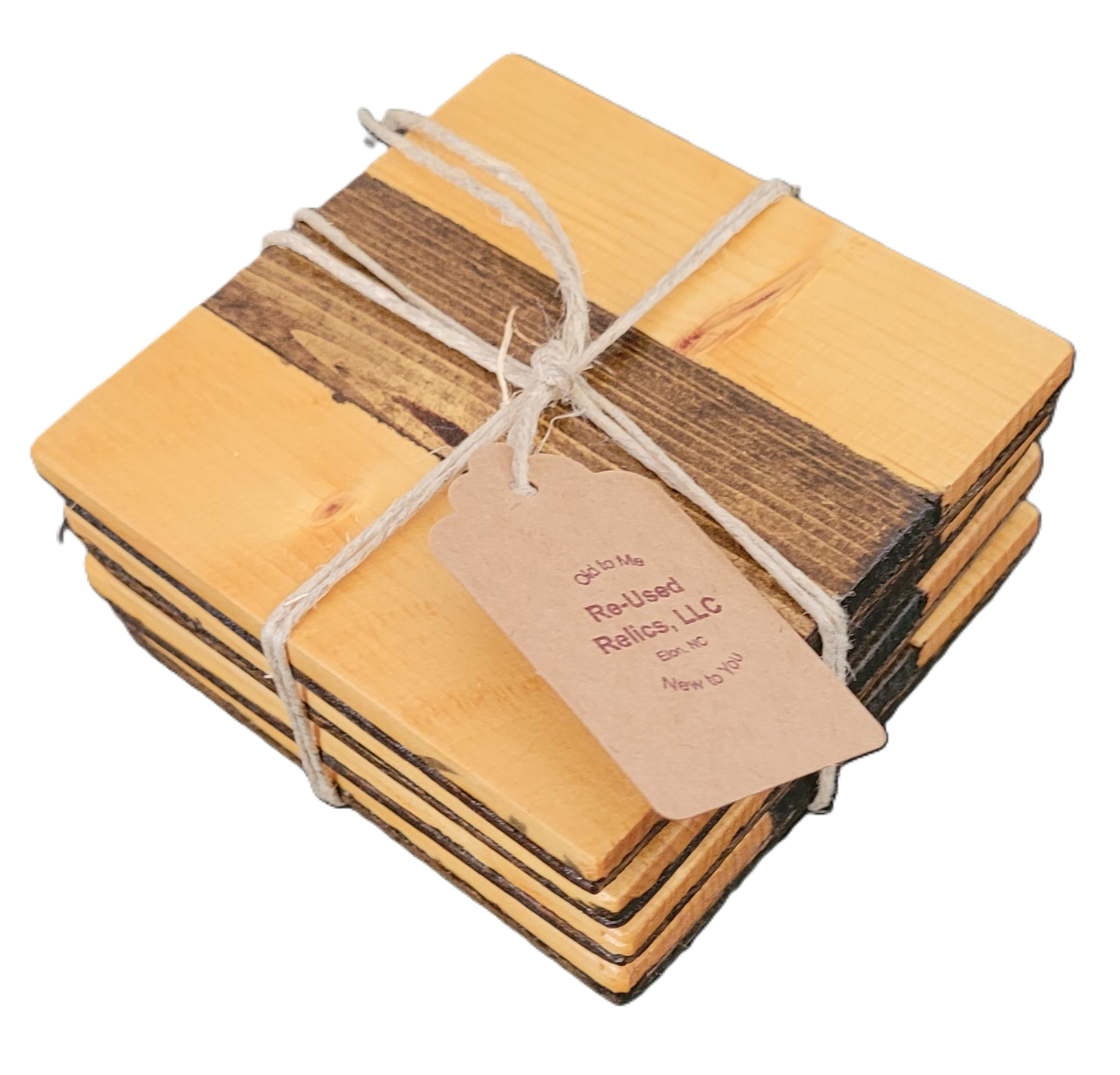Stack of wooden coasters tied with string and a tag on a dark background