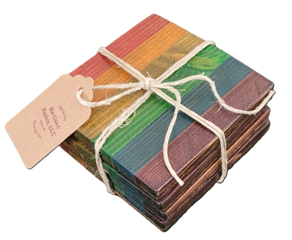 Stack of colorful wooden coasters tied with string on a dark background