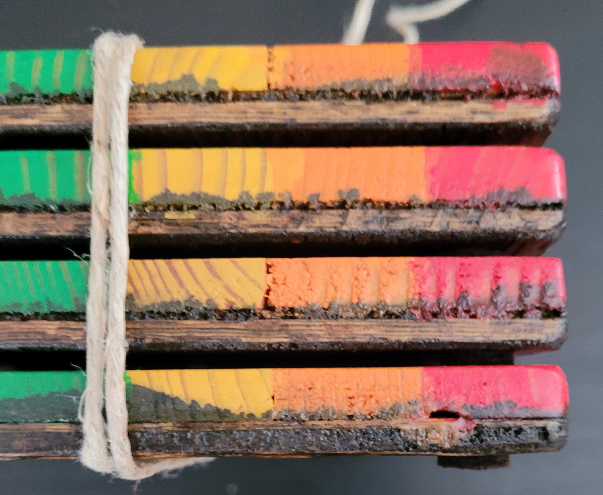 Close-up of side of a stack of four coasters.