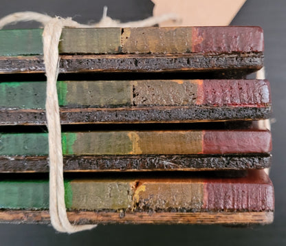 Close up side view of a stack of four coasters.
