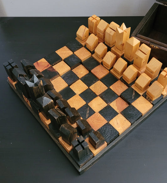Wooden chessboard with pieces on a dark surface