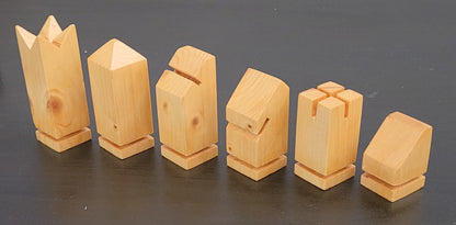 Set of wooden chess pieces on a dark surface