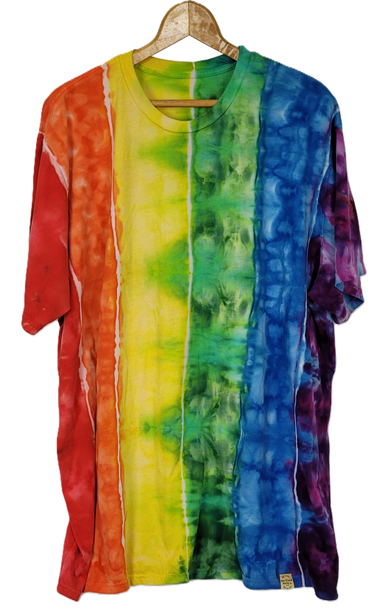 Colorful tie-dye shirt on a hanger against a white background