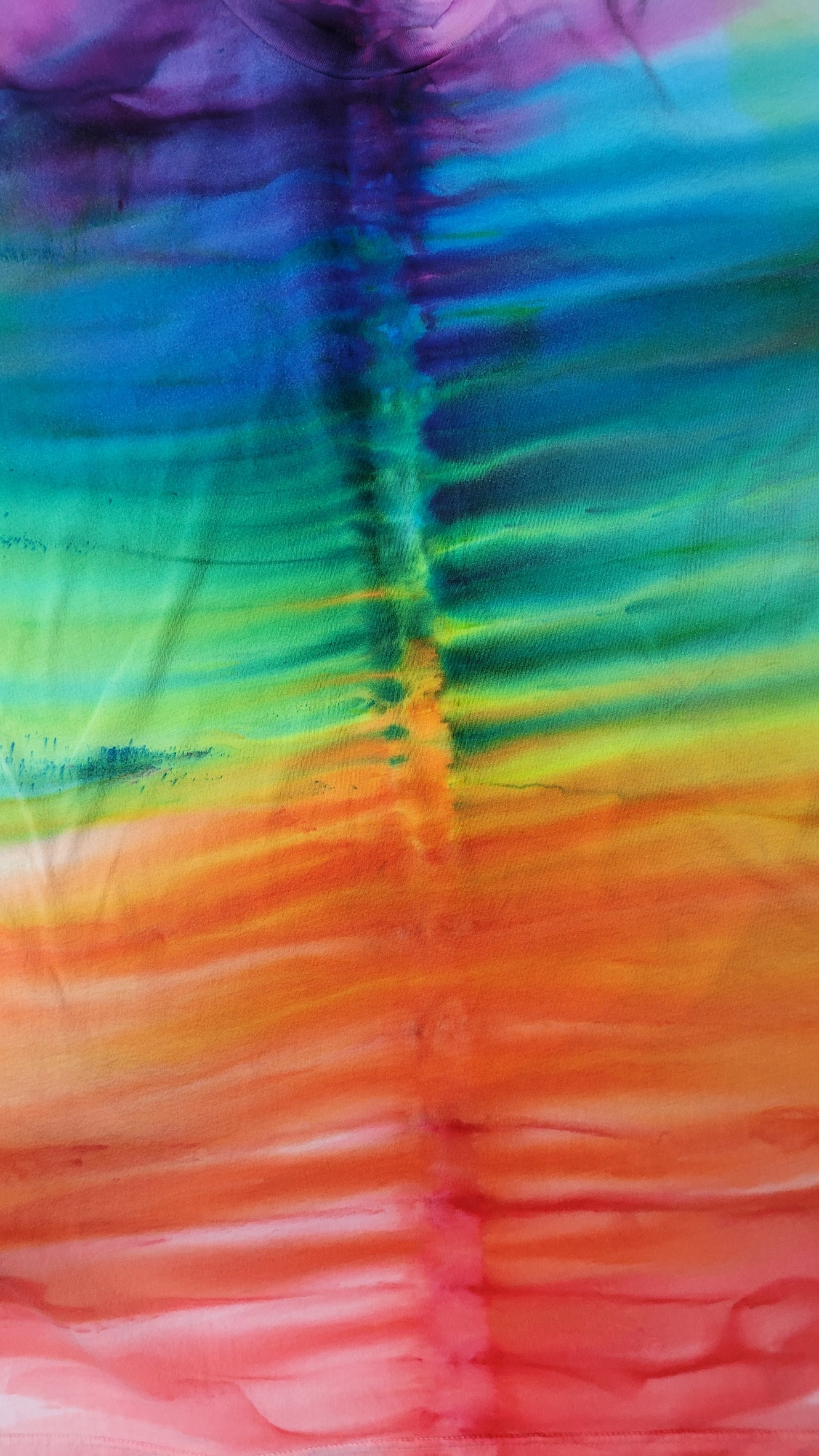 Close-up of a tie-dye fabric with a rainbow pattern
