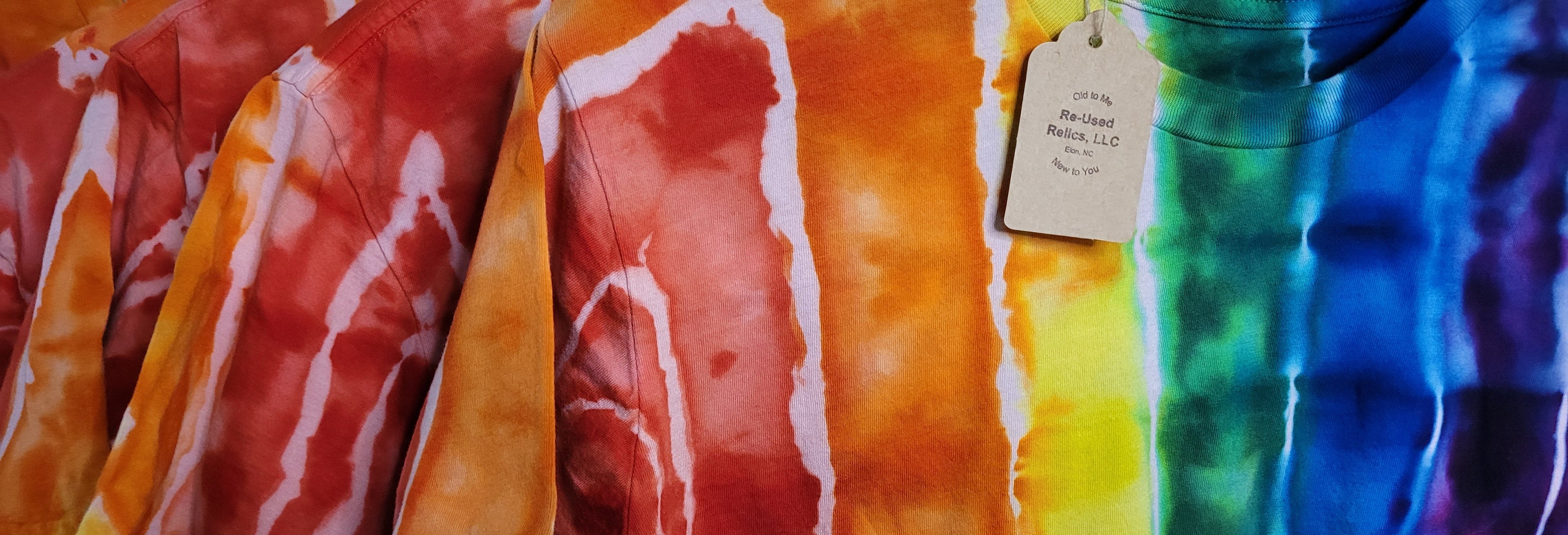 Colorful tie-dye fabric with a tag on a multicolored background