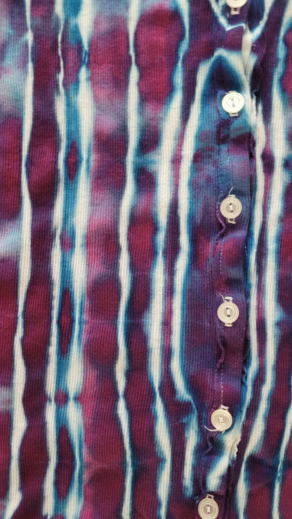 Close-up of a patterned fabric with horizontal stripes in purple, blue, and white.
