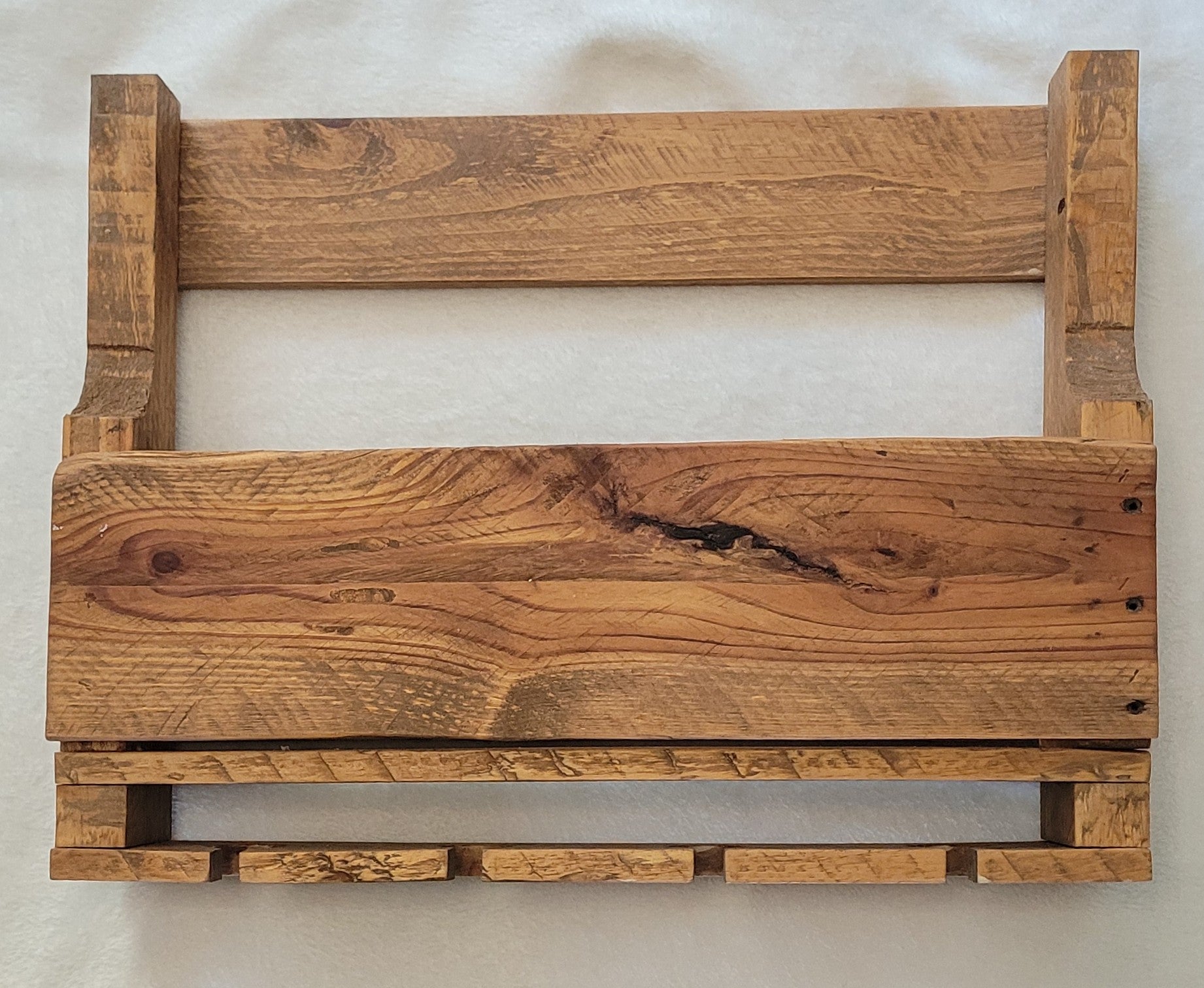 Wooden wine rack with a natural finish on a white background