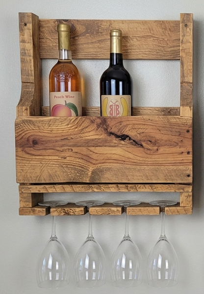 Wooden wine rack with two bottles and four glasses on a plain background