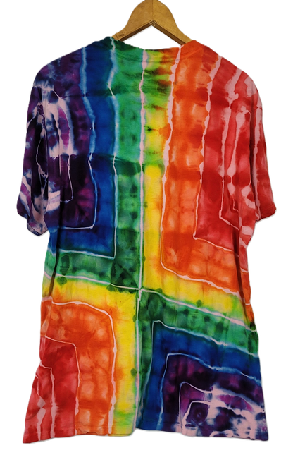 Multicolored tie-dye shirt on a hanger against a white background