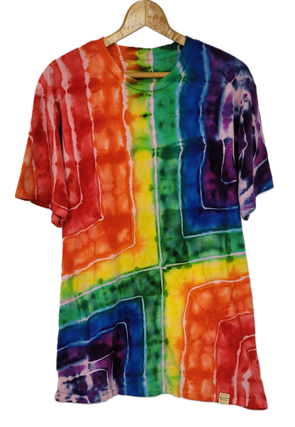 Multicolored tie-dye shirt on a hanger against a white background