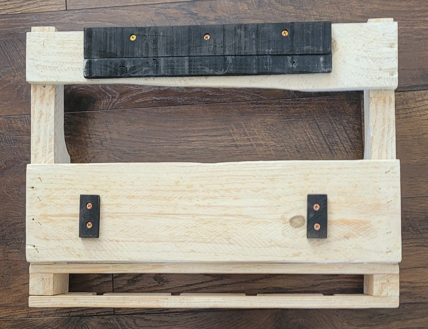 White washed wooden wine rack on a wooden floor