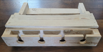 White washed wooden wine rack on a wooden surface