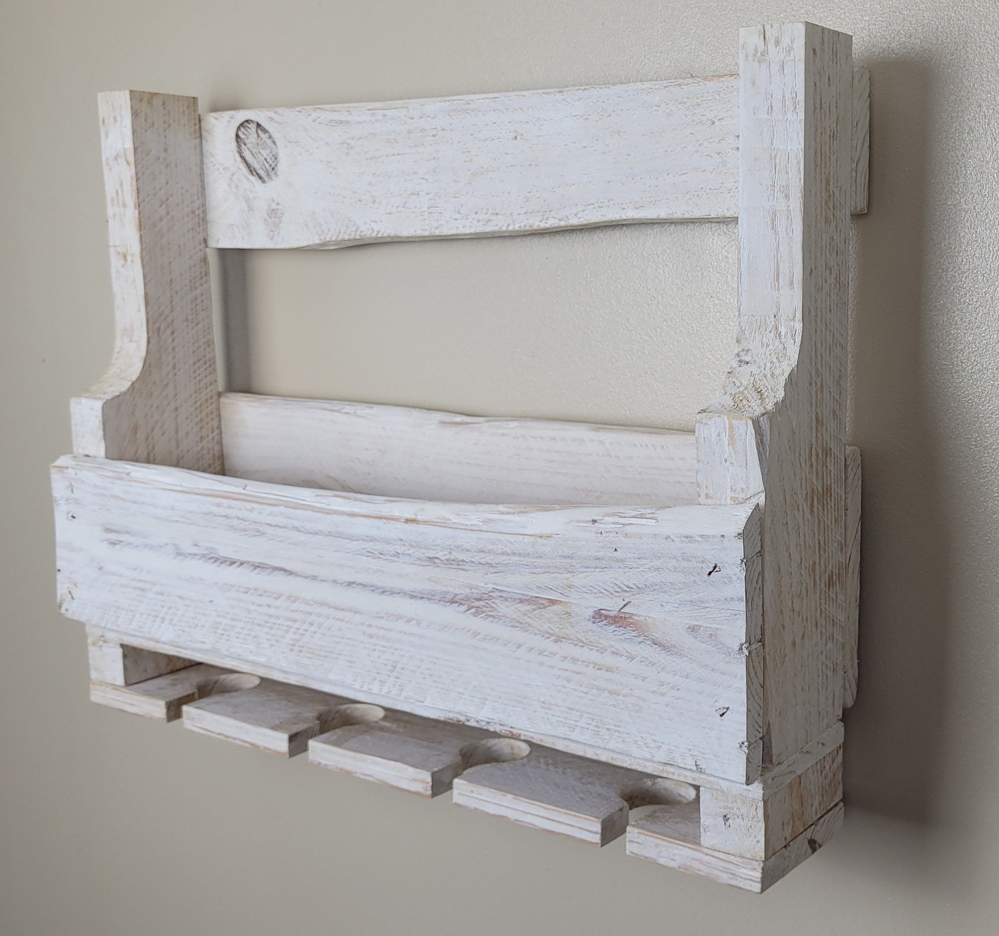 White washed wooden wine rack against a plain wall