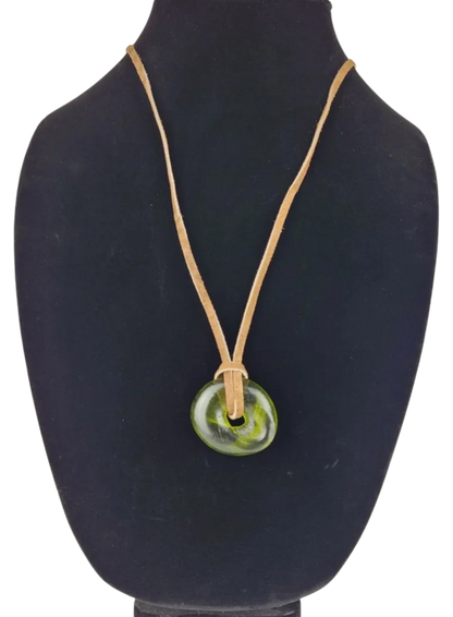 Necklace with a green pendant on a black mannequin bust