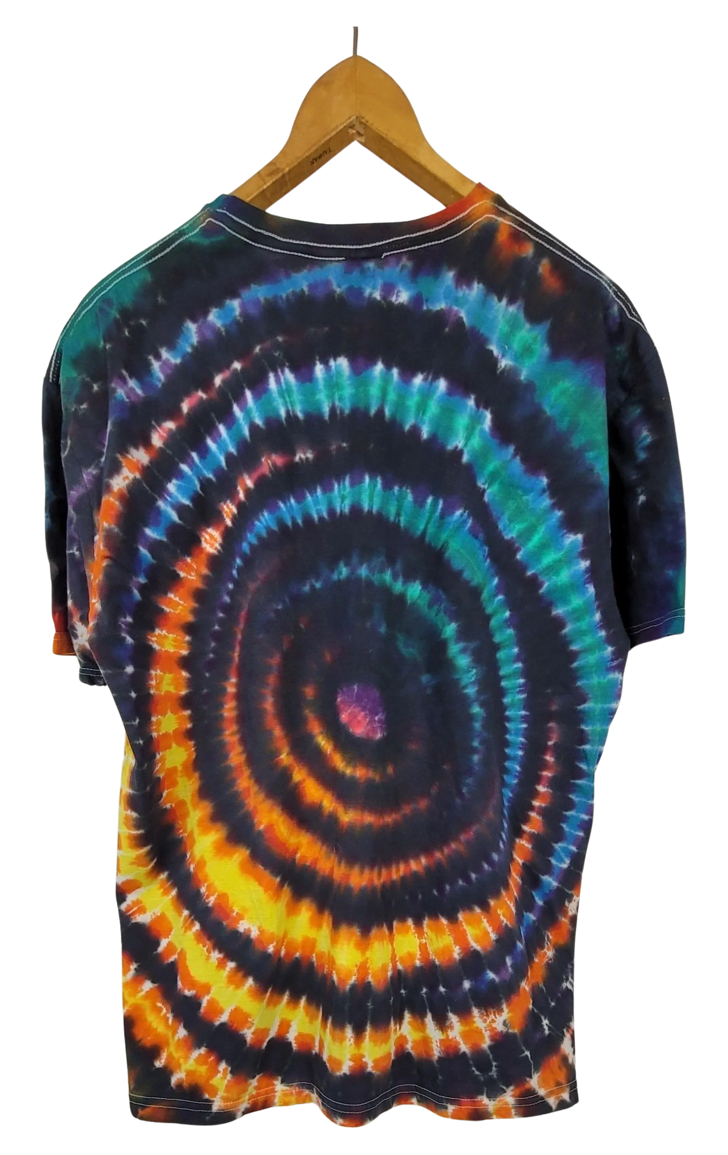 Tie-dye t-shirt with a wig wag pattern on a hanger against a white background