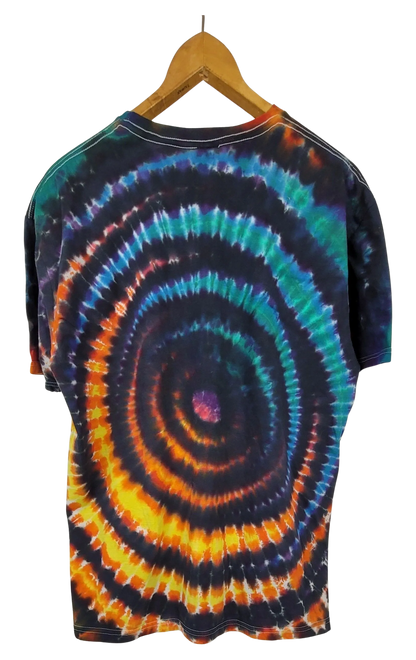 Tie-dye t-shirt with a wig wag pattern on a hanger against a white background