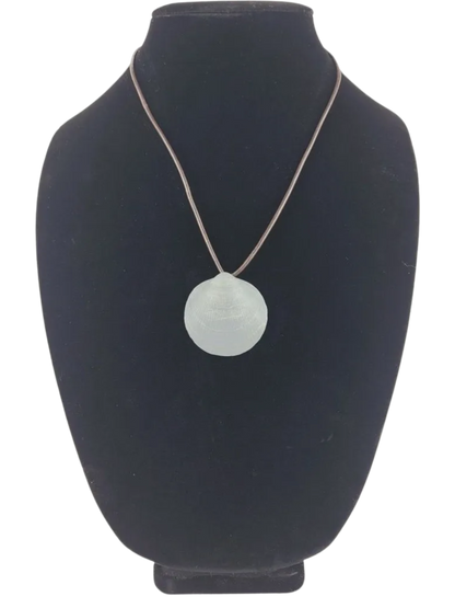 Necklace with a round pendant on a black bust